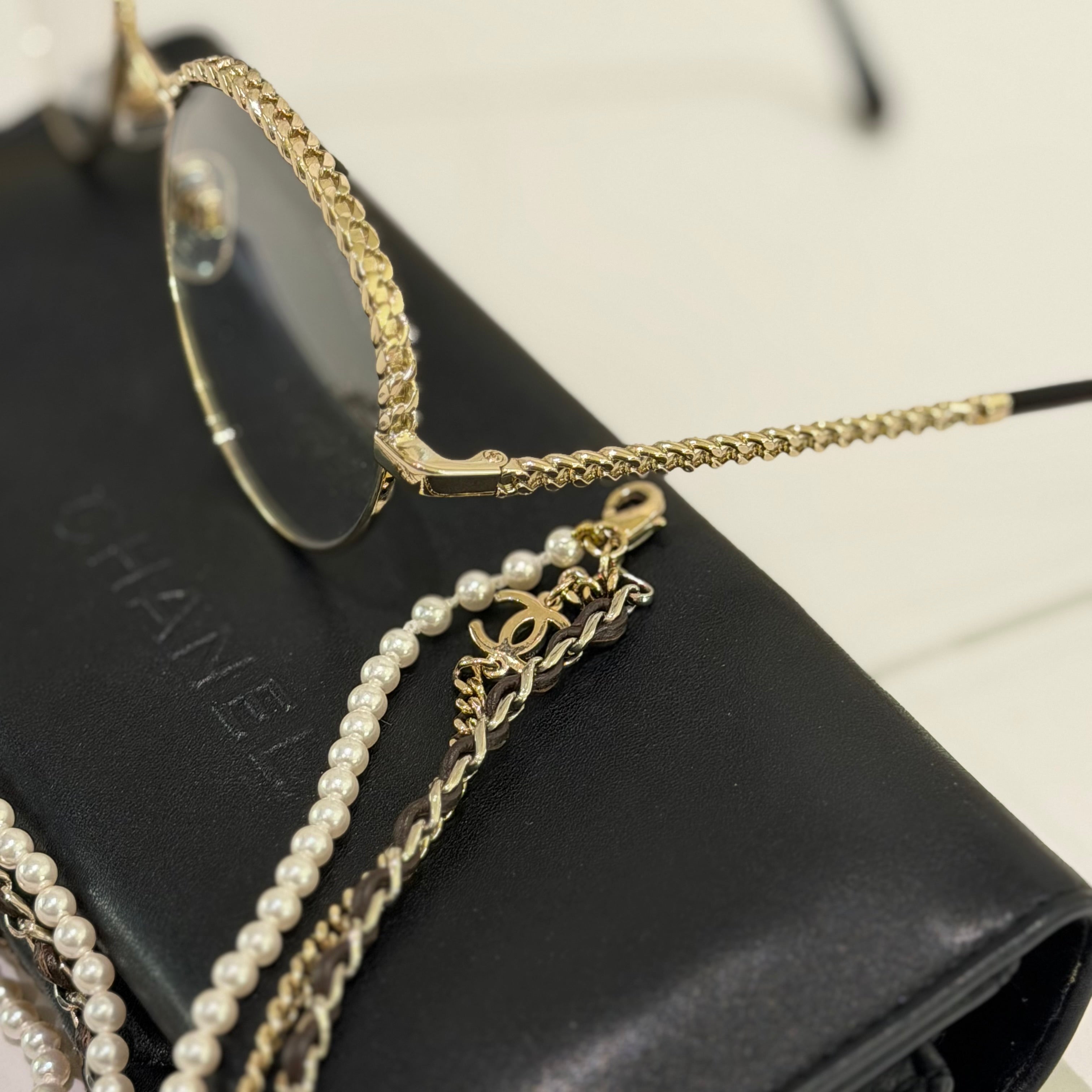 CHANEL BLACK FLAT GLASSES WITH GOLD PEARL CHAIN